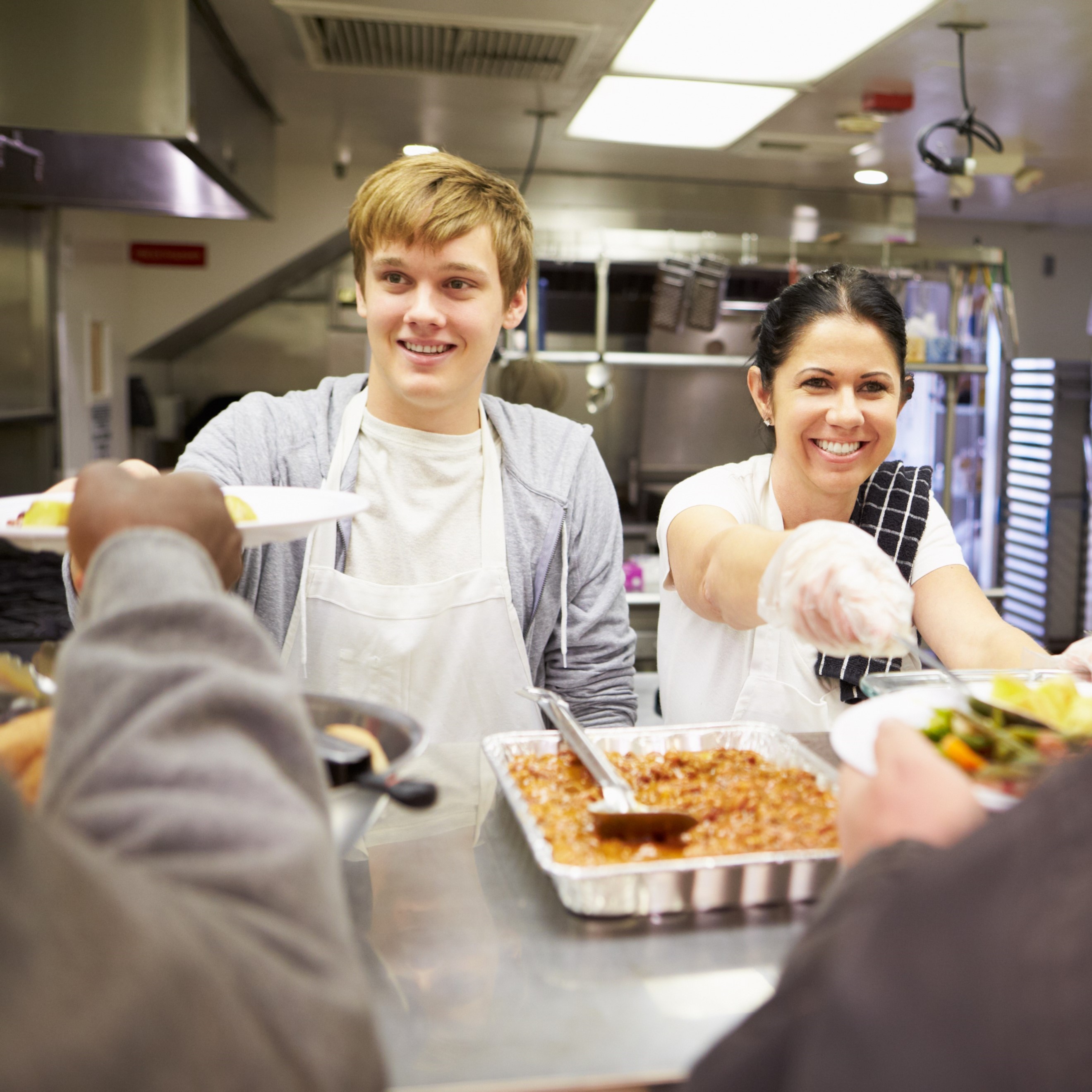 A woman and boy serve food