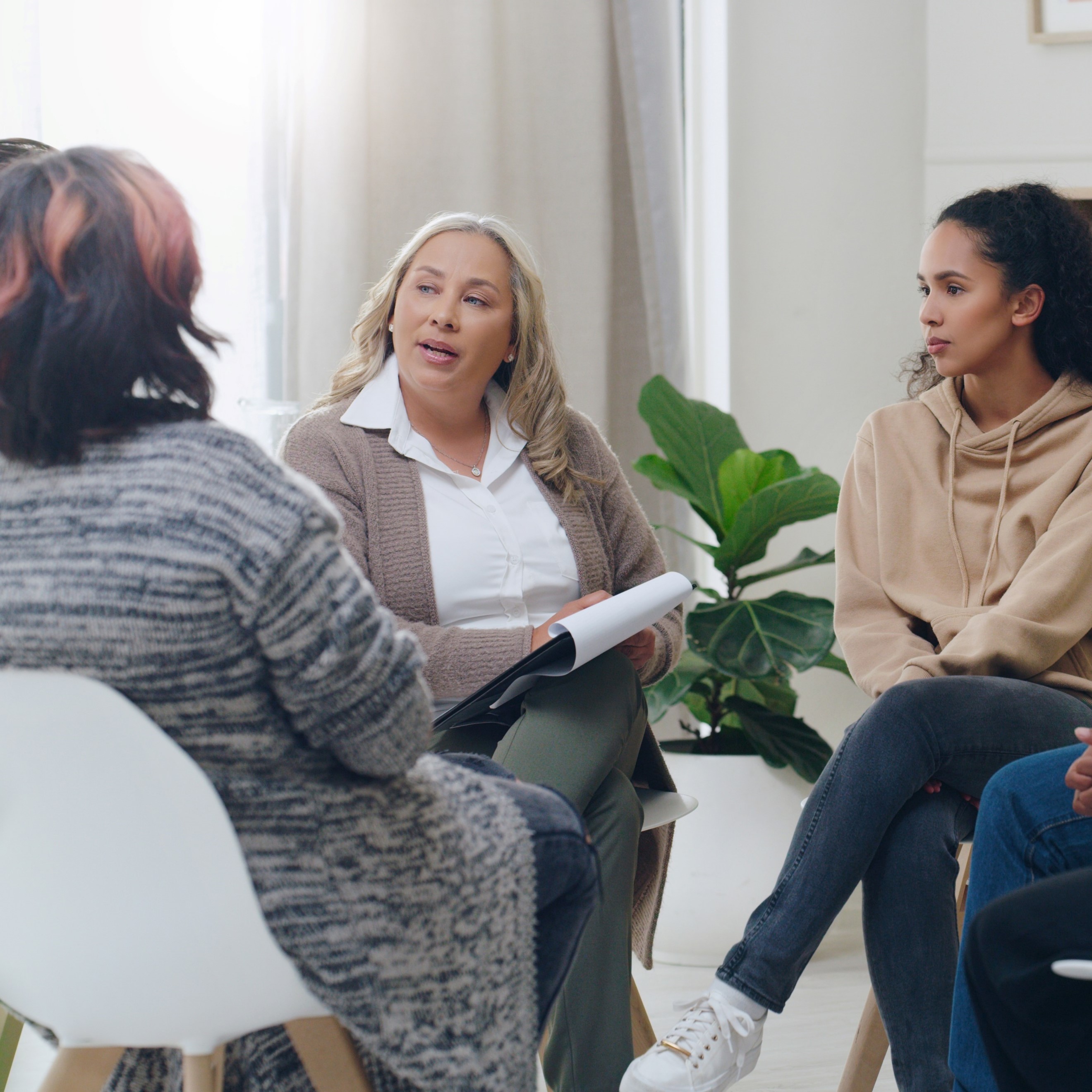 A woman leads a support group discussion